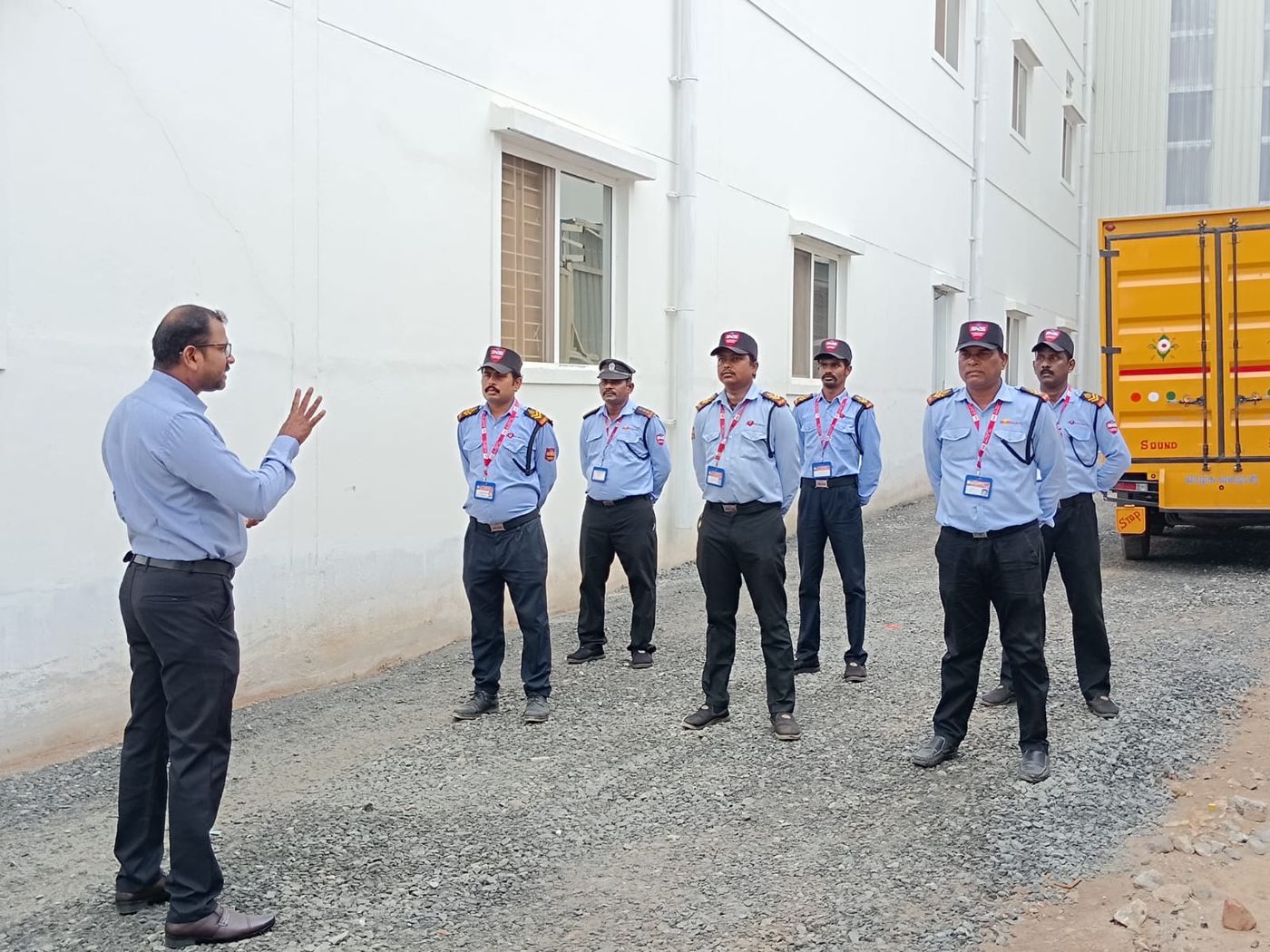 A supervisor briefing the incoming shift at a client site in Coimbatore.